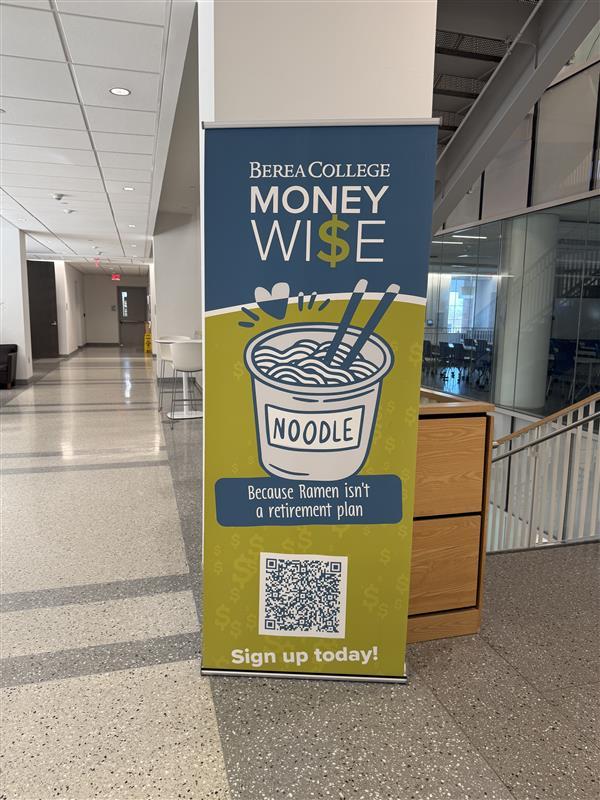 A blue and chartreuse banner advertises the MoneyWi$e program, showing a cartoon graphic of ramen noodles and the phrase, "Because ramen isn't a retirement plan."
