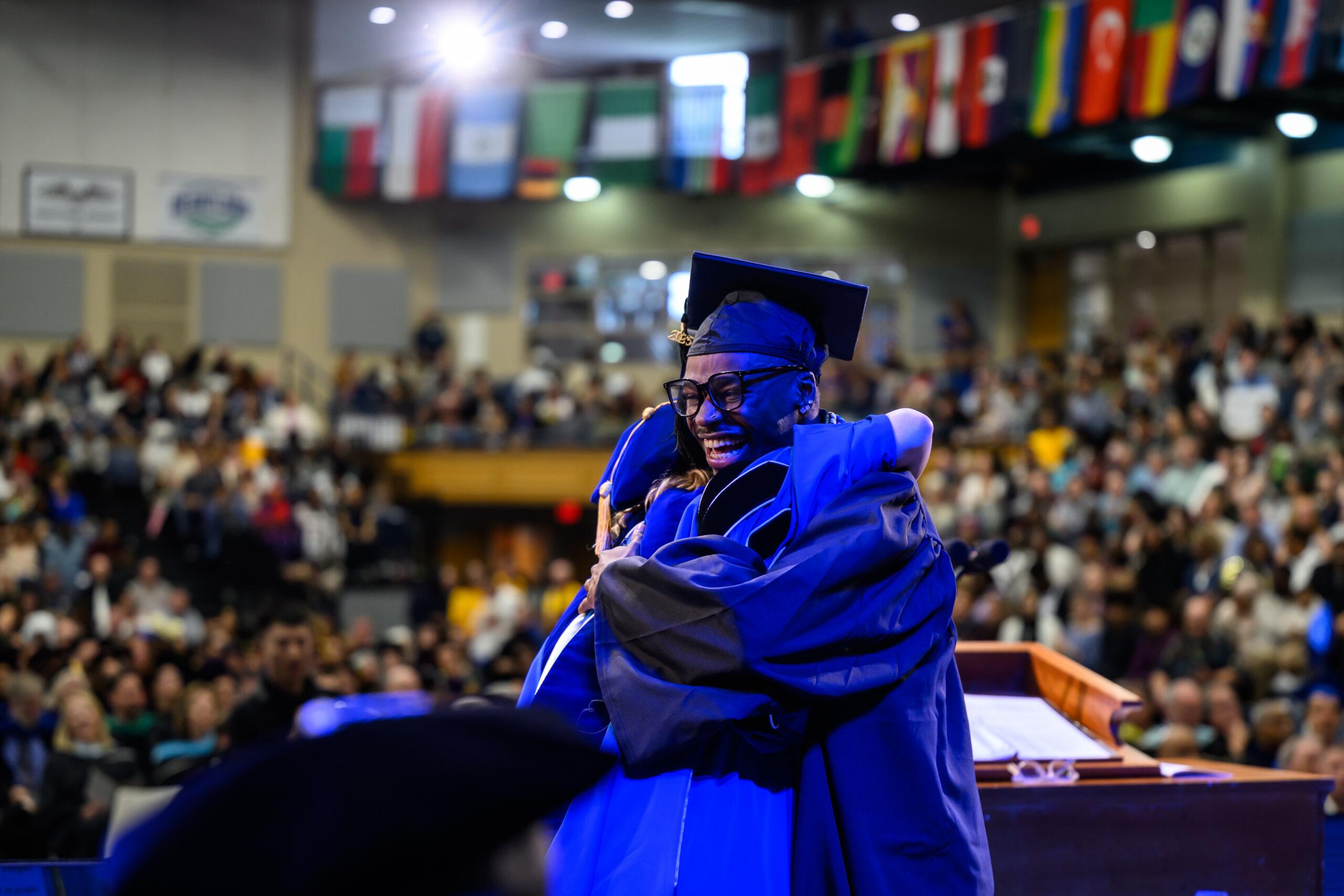 A student at Berea College receives their diploma at graduation